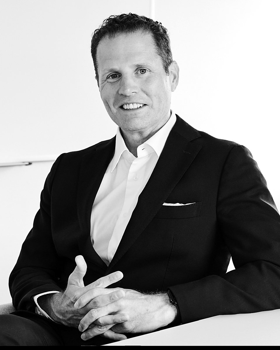 Dave Corcoran, CPA, seated at a conference table in a dark suit